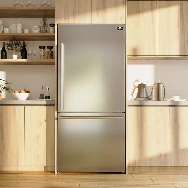 Lifestyle view of the FORNO 31-inch right-hinge refrigerator in stainless steel, seamlessly integrated into a contemporary kitchen setting with surrounding cabinetry and decor.
