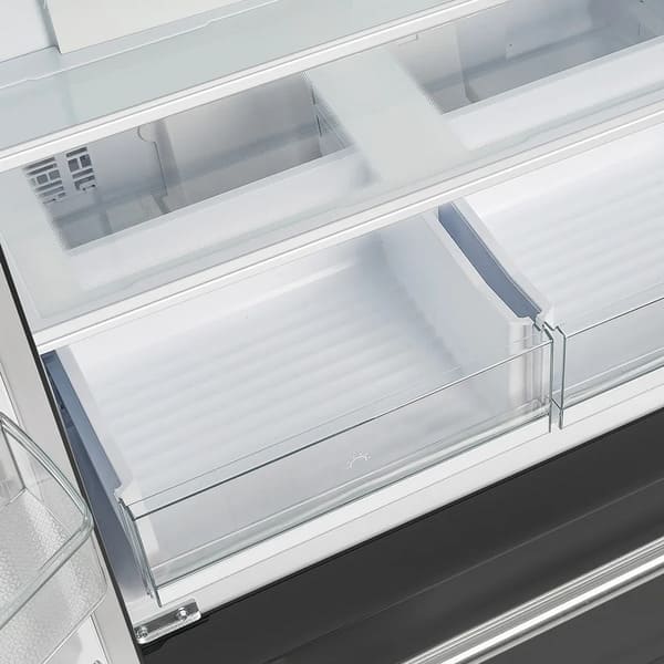 Close-up view of the Forno 36-inch French door refrigerator's crisper drawers, featuring two clear, spacious compartments designed to keep fruits and vegetables fresh.