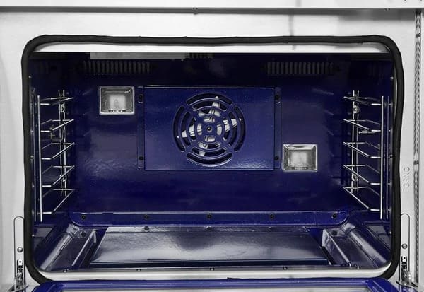 Interior view of the FORNO 48-inch gas range from the 2-Piece Appliance Package, showing dual oven cavities with stainless steel interiors, multiple rack positions, convection fans, and interior lighting—designed for even cooking and versatile baking performance.
