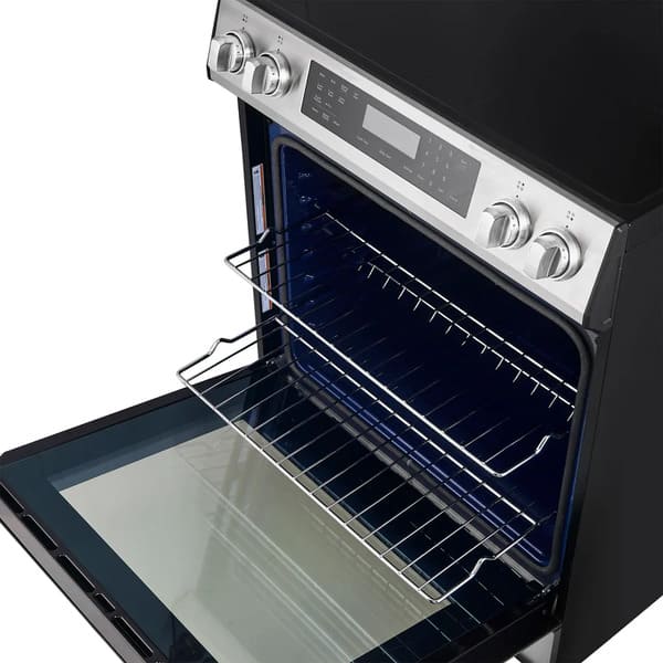 Interior view of the FORNO 30-inch induction range in stainless steel, displaying durable oven racks with multiple adjustable positions for flexible cooking configurations.