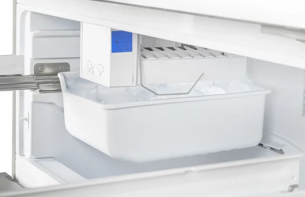 Side view of the ice maker inside the FORNO 36-inch French door refrigerator, featuring a built-in automatic ice dispenser—part of the FORNO 3-piece stainless steel appliance package.