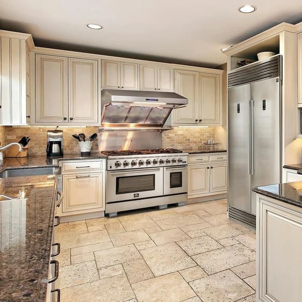 Lifestyle kitchen setting showcasing the FORNO 3-Piece Appliance Package, including the 48-inch Capriasca gas range, 60-inch pro-style refrigerator, and stainless steel wall mount range hood—all seamlessly integrated into a modern kitchen with premium finishes and spacious layout.