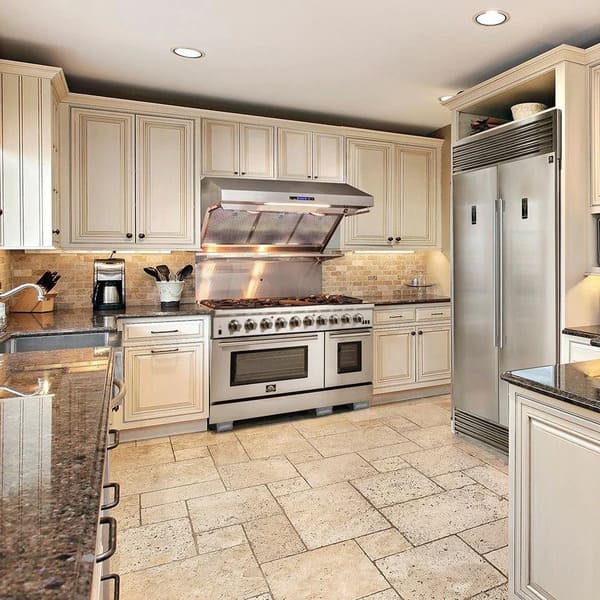 Lifestyle kitchen view showcasing the FORNO 3-Piece Appliance Package, including a 48-inch gas range, a 60-inch pro-style refrigerator, and a wall mount range hood, all in stainless steel, seamlessly integrated into a modern, high-end kitchen setting.