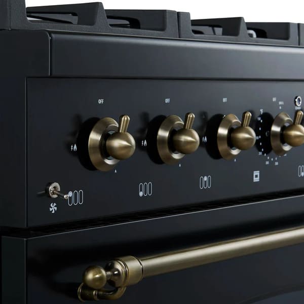 Close-up view of the control knobs on the FORNO Antico 36-Inch Gas Range in black, featuring polished brass bezels, stainless steel knobs, and precision heat markings for professional-grade control.