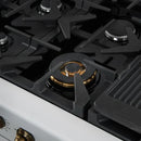 Close-up of a brass burner on the FORNO Antico 48-Inch Dual Fuel Range in white, showing precision flame ports, durable cast iron grates, and a clean stainless steel surface.