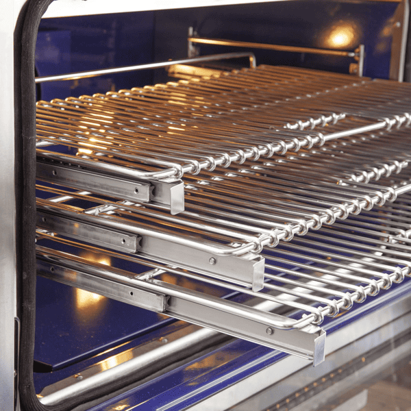 Interior view of FORNO Capriasca 36-Inch Gas Range featuring blue enamel cavity, convection fan, and three stainless steel telescopic oven racks.