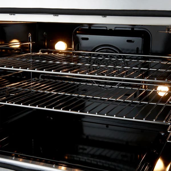 Close-up of the oven interior in the FORNO Galiano 30-Inch French Door Dual Fuel Range in black, featuring a blue enamel finish with stainless steel racks on smooth ball-bearing glides for easy access.