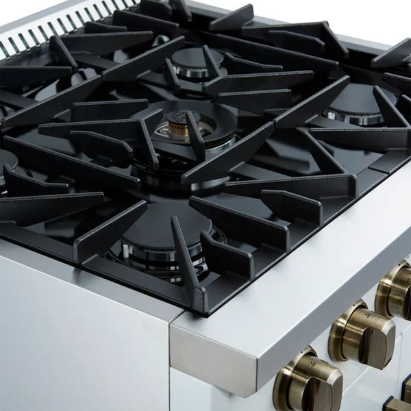 Left-angled view of the FORNO Galiano 30-Inch French Door Gas Range in white, showcasing four brass burners, heavy-duty cast iron grates, and a matte white cooktop surface designed for precision and durability.