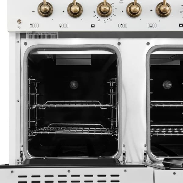 Interior view of the secondary oven in the Forno Antico 48-Inch Gas Range in white, showcasing a blue enamel finish, convection fan, and adjustable oven rack for smaller-scale cooking.